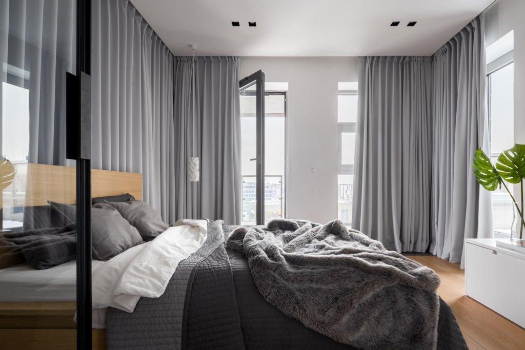 double bed and gray window curtains